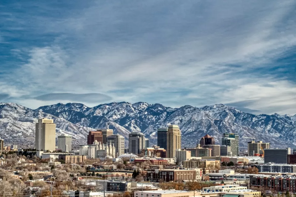 View of Salt Lake City, Utah skyline with snowy mountains in background.